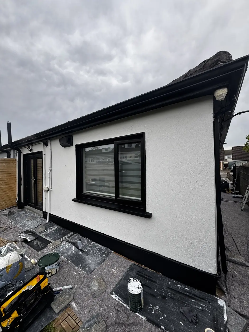 Fresh white exterior walls with black window frames and trim painted in Dublin